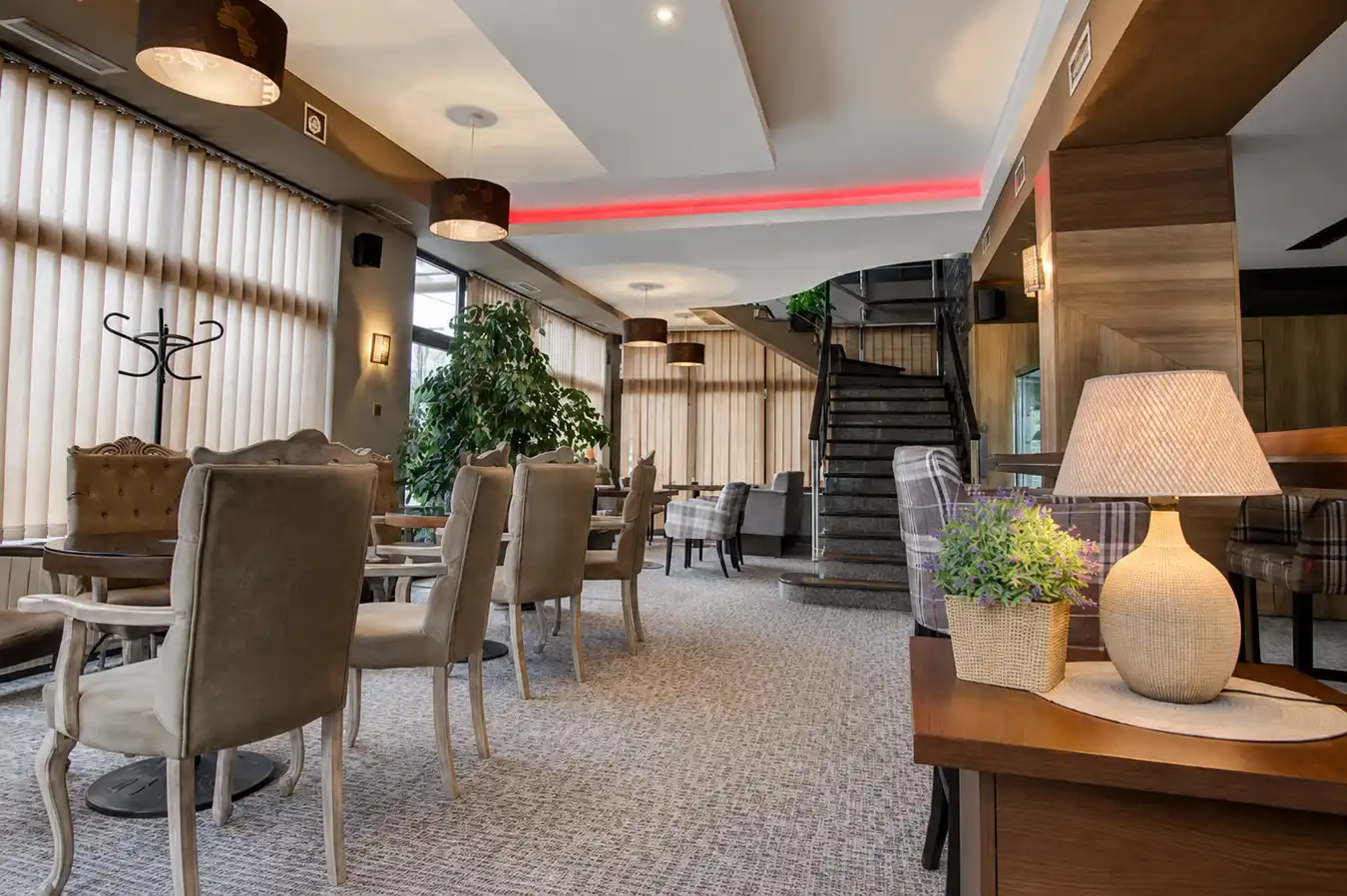 Dining room of Restaurant Zlatna Žita with upholstered chairs and warm lighting